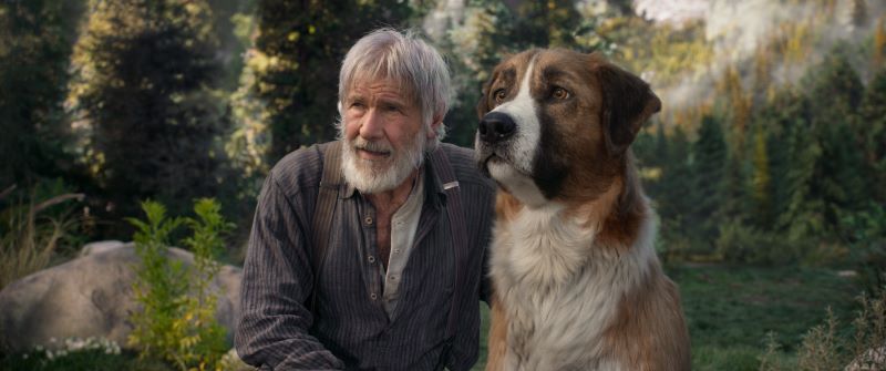 Harrison Ford ao lado de um grande cão branco e marrom.